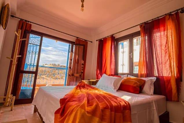 Private ensuite room with a double bed and a balcony overlooking Tamraght, Morocco – photo 1