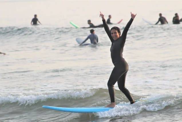 A beginner celebrating her first wave at Tamraght on Morocco’s Atlantic coast