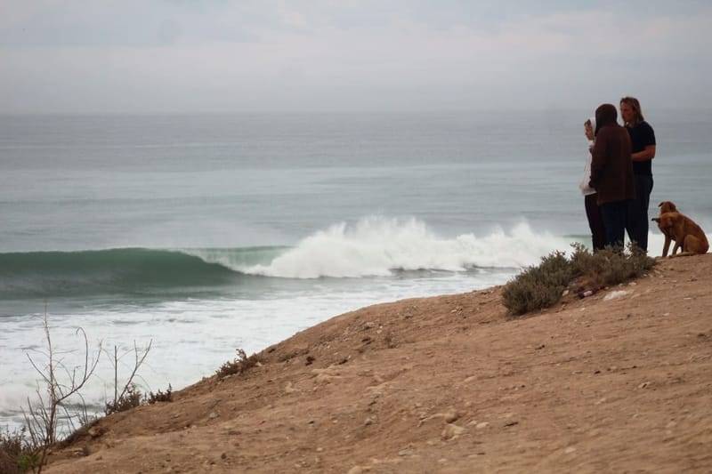 Watching a clean wave break from the cliff above a point break near Tamraght, Morocco