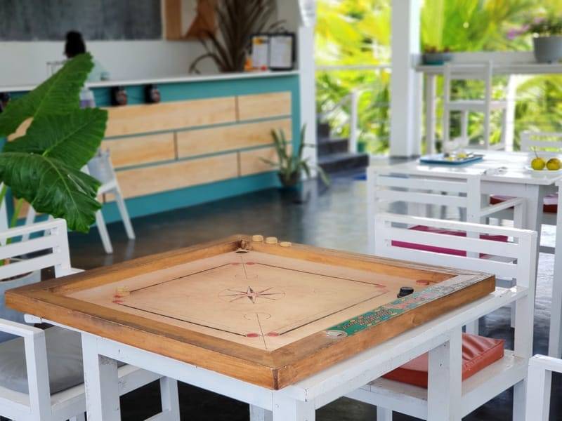 Carrom board in the open-air common area at The Surfer TS2 Camp, Weligama