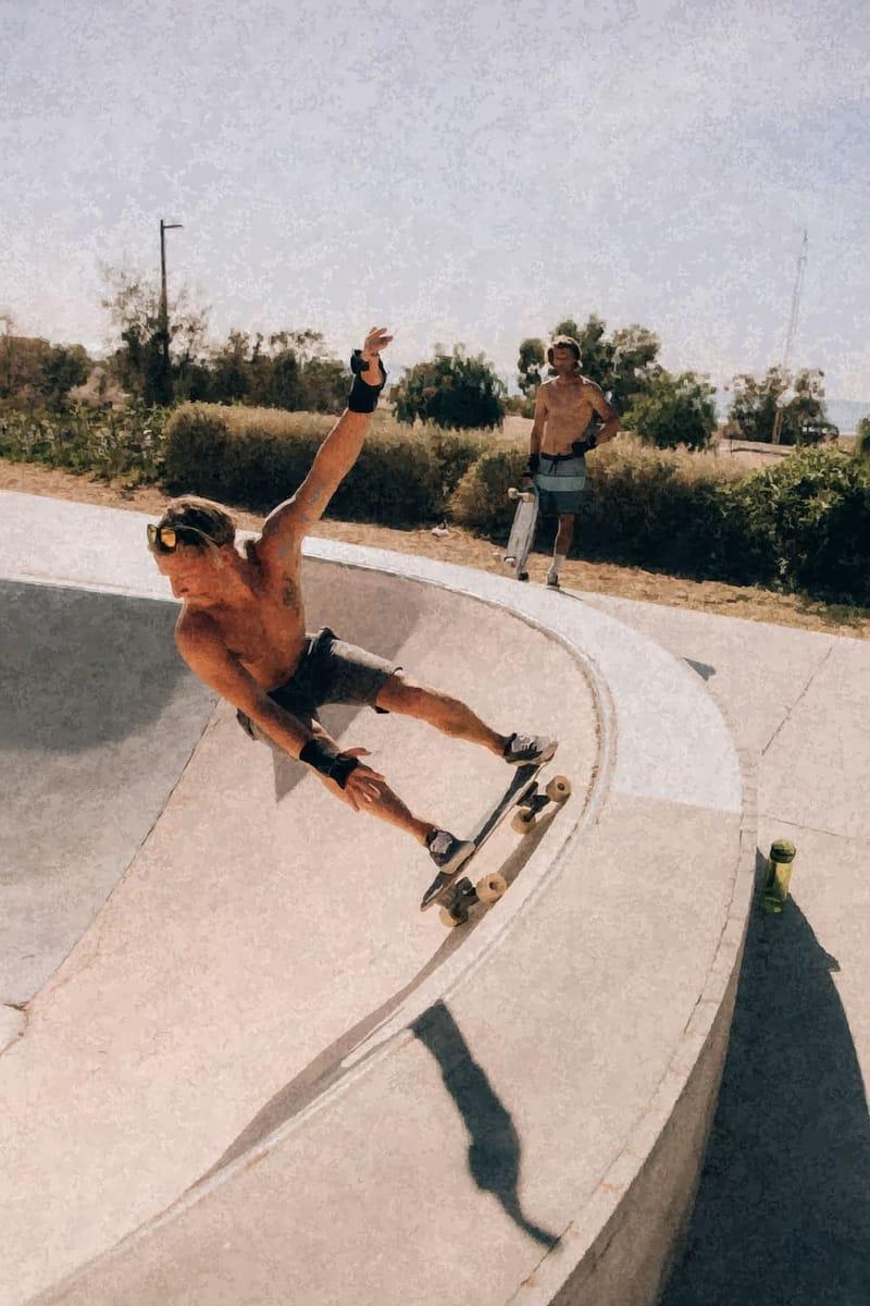 A skateboarder carving the concrete bowl at the Tamraght skatepark, Morocco