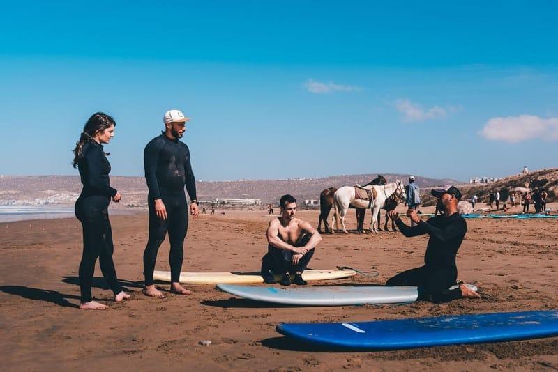 Surf instructor briefing students on the beach at Tamraght, Morocco