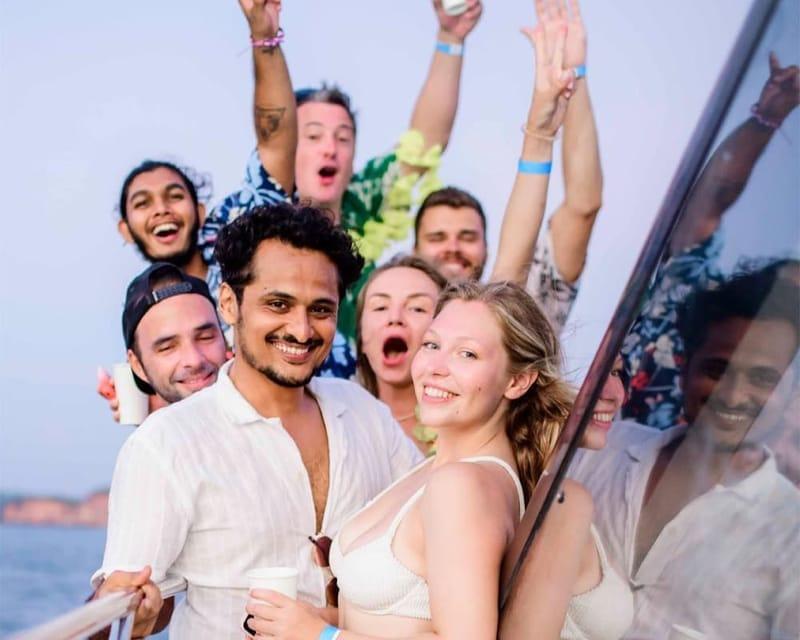 Guests laughing together on the boat at dusk during The Surfer boat party