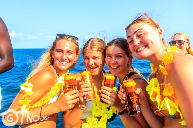 Four guests toasting drinks during The Surfer boat party off Weligama